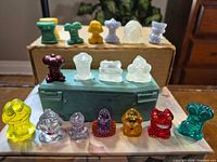 Full lot showing 12 front-row and 6 rear-row Crazy Bones figures lined on box and case