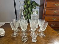 Group shot showing all glasses, decanters, shot glass and candle holder