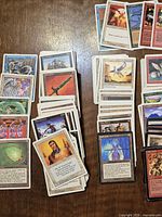 Stacks of assorted Magic cards spread on table