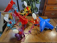 Chandelier lying on surface with bulbs installed and blue star night light beside it