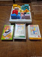 Top view of assembled Rush Hour board with vehicle pieces and three card decks