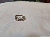 Front view displaying seven clear stones set across band