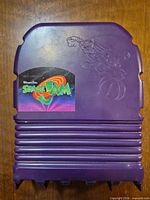 Purple case lid with Space Jam logo sticker and embossed Bugs Bunny