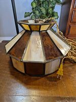 Side view of stained glass pendant showing color pattern and plug