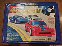 Lid of blue 48-slot car case with graphics