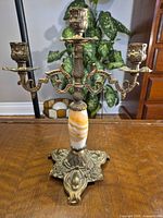 Front view showing three arms, onyx column, ornate base