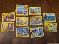 Fronts of all 11 trading cards showing illustrations and yellow borders