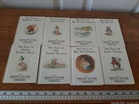 Front covers of eight Beatrix Potter hardcovers arranged in two rows