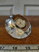Front angled view showing crystal body and clock face
