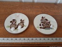 Both circular rabbit embroidery pieces beside ruler indicating 6 in diameter