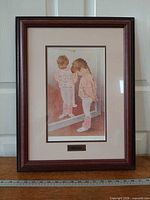 Full view of framed print showing artwork, mat, frame and brass title plaque