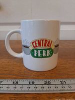 Front view showing Central Perk logo on mug