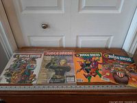 Four Judge Dredd comic books laid side by side