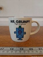 Front view showing Mr. Grumpy graphic and text, ruler for scale
