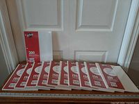 Front view all eleven packs on table showing quantities 150 and 200 sheets