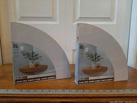 Front view showing two sealed Homedeco corner shelf packages