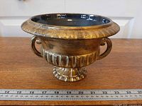 Front view showing full urn with ruler for scale