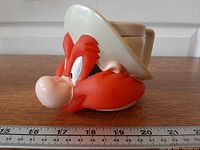Front view showing Yosemite Sam face, size reference with ruler