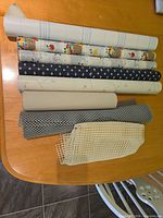 Overall view of nine assorted rolls and mesh liners on table