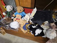 Group of teddy bears and assorted faux fur and fabric pieces on shelf