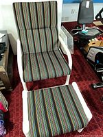 Front view of striped lounge chair with ottoman