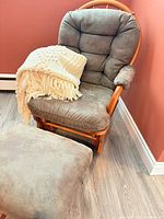 Glider chair with ottoman and knit throw showing overall appearance
