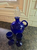 Decanter with stopper and two glasses displayed together
