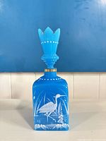 front view showing bottle, stopper, painted heron design