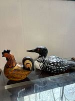 front view of both wooden bird carvings