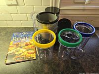 Booklet and four cups with coloured rings