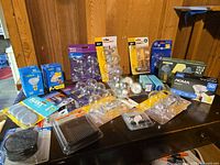 Overall lot view showing multiple packaged light bulbs of various brands and types
