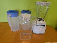 Group shot showing blender, glass pitcher and two plastic pitchers