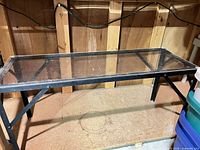 Full view of table showing clear top and metal frame