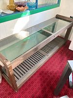 full view of the console table showing glass top and slatted lower shelf