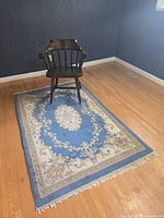 Chair centered on rug in room