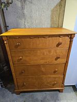 Full front view of the four-drawer dresser