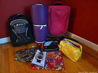 Group shot of backpack, suitcase, foam mat, pouches, organizer, scale