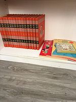 Childcraft volumes and additional books on shelf