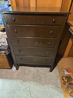 Front view of dresser showing five drawers and wooden knobs