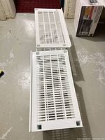 two unassembled shelf pieces showing slatted design