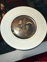 Front view showing full plate with raised border and central image