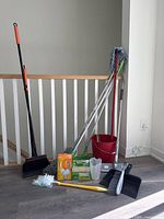 Full lot showing broom, bucket, mops, Swiffer refills, dustpan, brush, jug