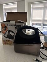 Mixer front view beside box on countertop