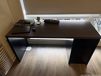 Full view of desk showing laminate top and pedestal