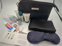 All kit contents displayed: pouch, toiletries, toothpaste, eye mask, earplugs, accessory case, card