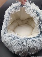 Top view showing semi-enclosed opening, plush interior cushion