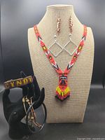 Entire lot displayed: necklace on bust, two earring pairs, two bracelets on hand display