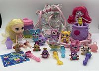 Overview of entire lot with dolls, figures, wands, cauldrons and sequin bag displayed