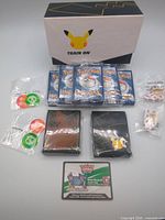 Lot overview with ETB box, energy packs, sleeves, dice, markers