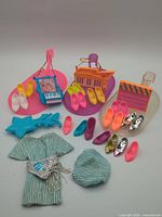 Group shot of all items—dress, beret, blue star accessory, three stage bases, nine pairs shoes